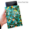 Hand holding a Kindle sleeve with snap to protect Kindle E-readers. Made with a teal floral featuring lemons and oranges with a yellow snap.